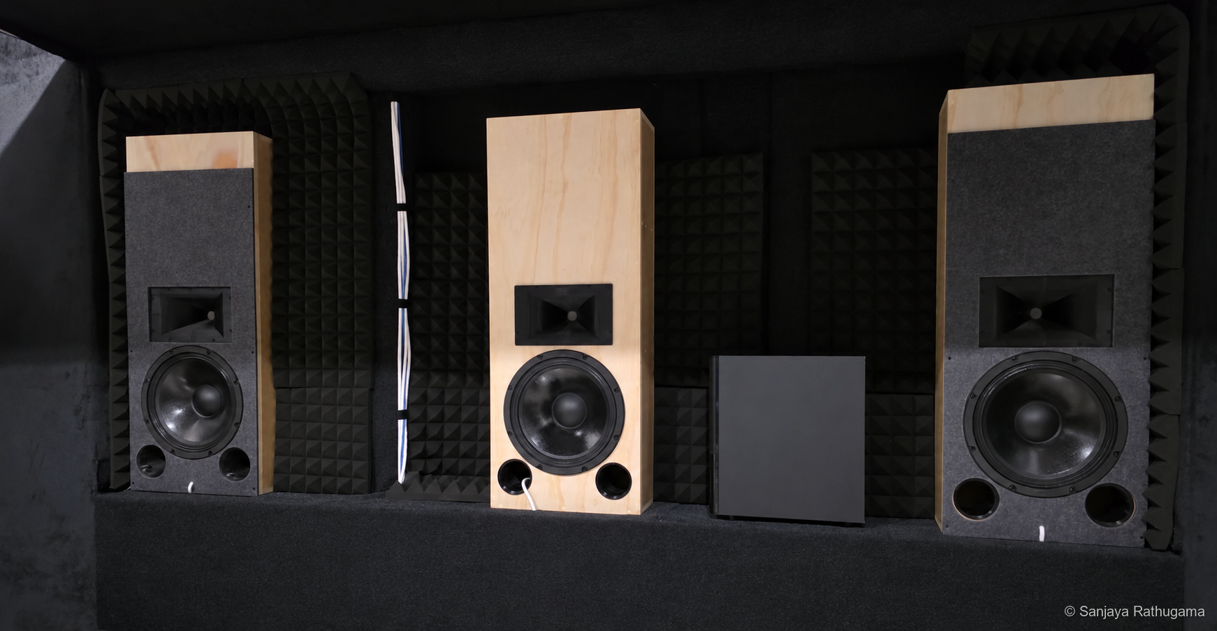 Three custom horn-loaded LCR speakers installed in the developing home-theatre front wall